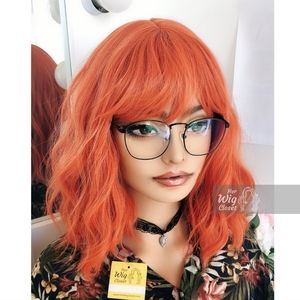 Orange synthetic wig with bangs, natural wave